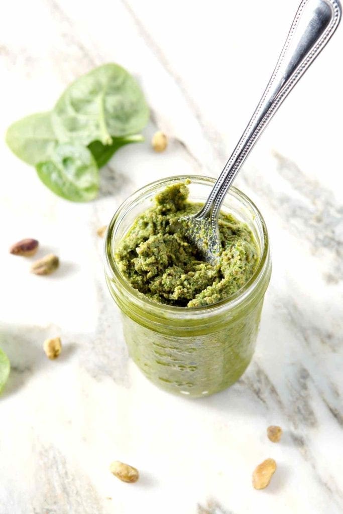 a spoon in pistachio pesto 