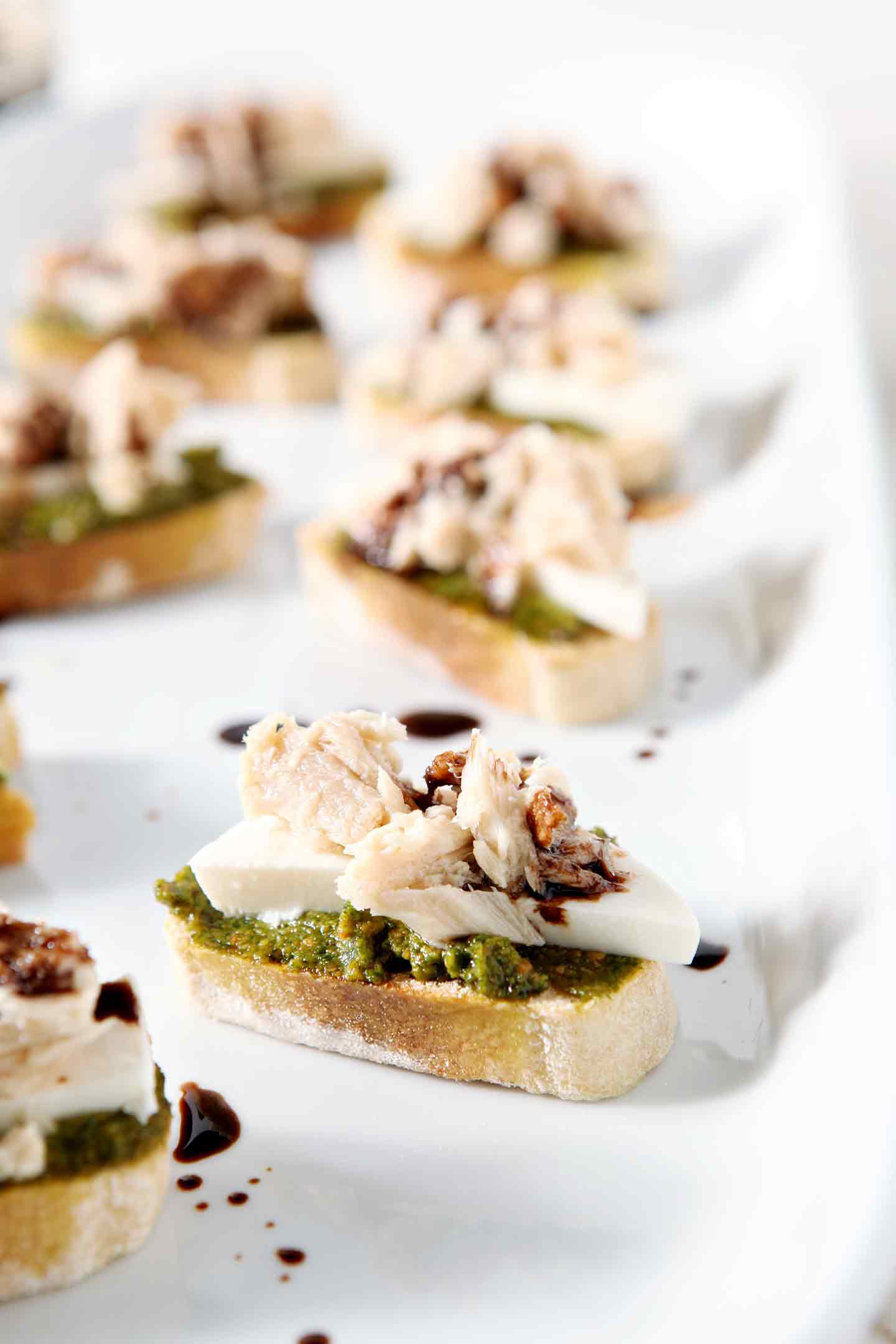 tuna pesto crostini on a white tray