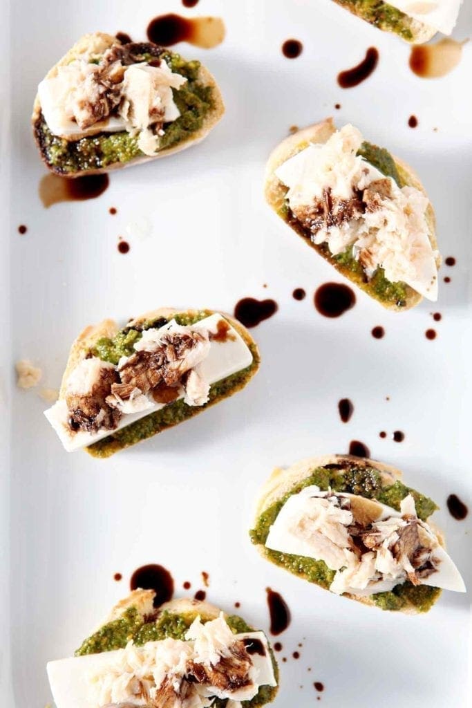 tuna pesto crostini on a white plate