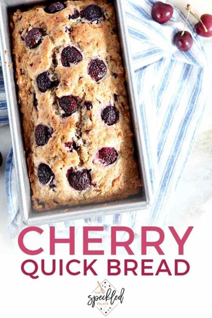 A loaf of Fresh Cherry Bread in its pan on top of a blue and white striped towel with the text 'cherry quick bread'