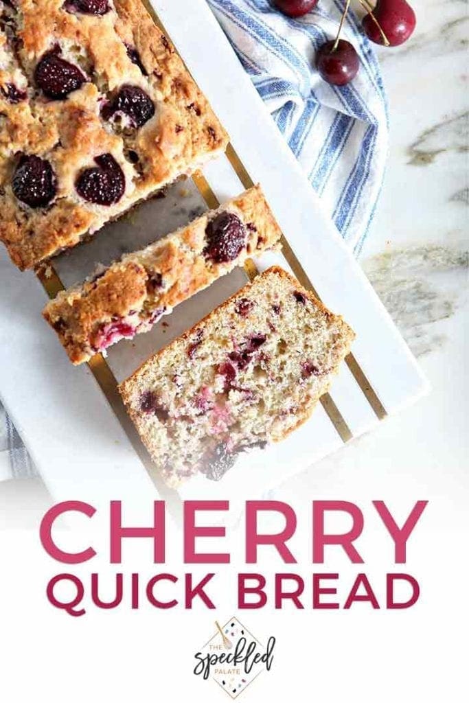 Slices of cherry bread on a marble tray over a blue and white striped towel with the text 'cherry quick bread'