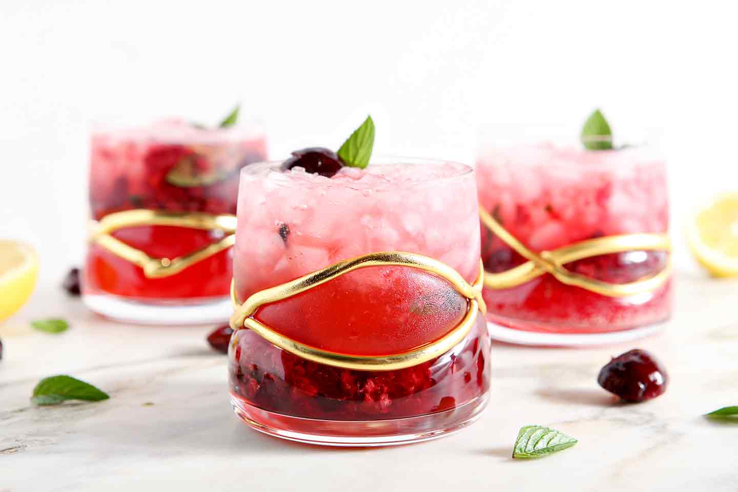 Three Cherry Smash cocktails on marble