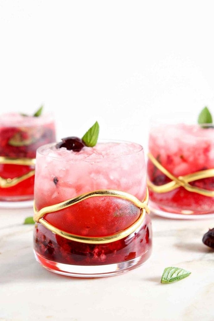 Three Cherry Smash cocktails on marble