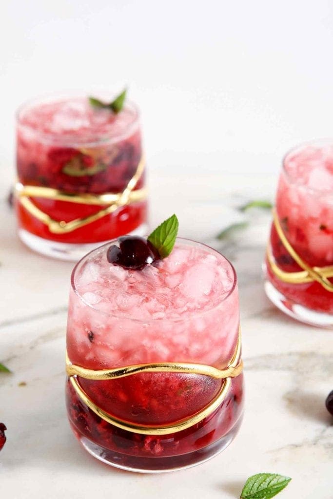 Three ombre pink Cherry Smash Cocktails on marble