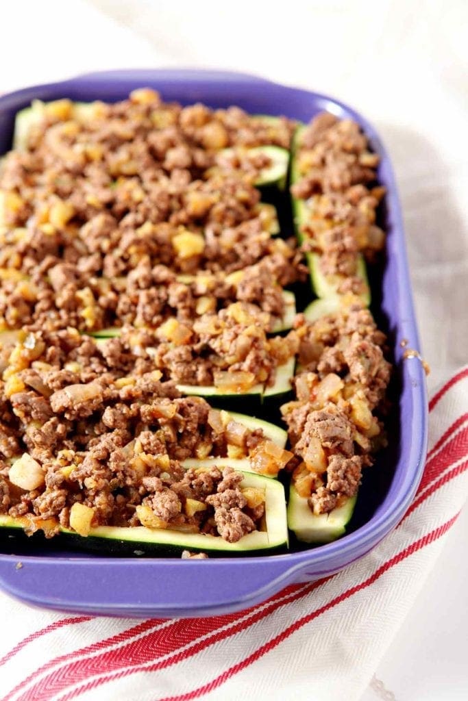 taco zucchin boats in a purple baking dish