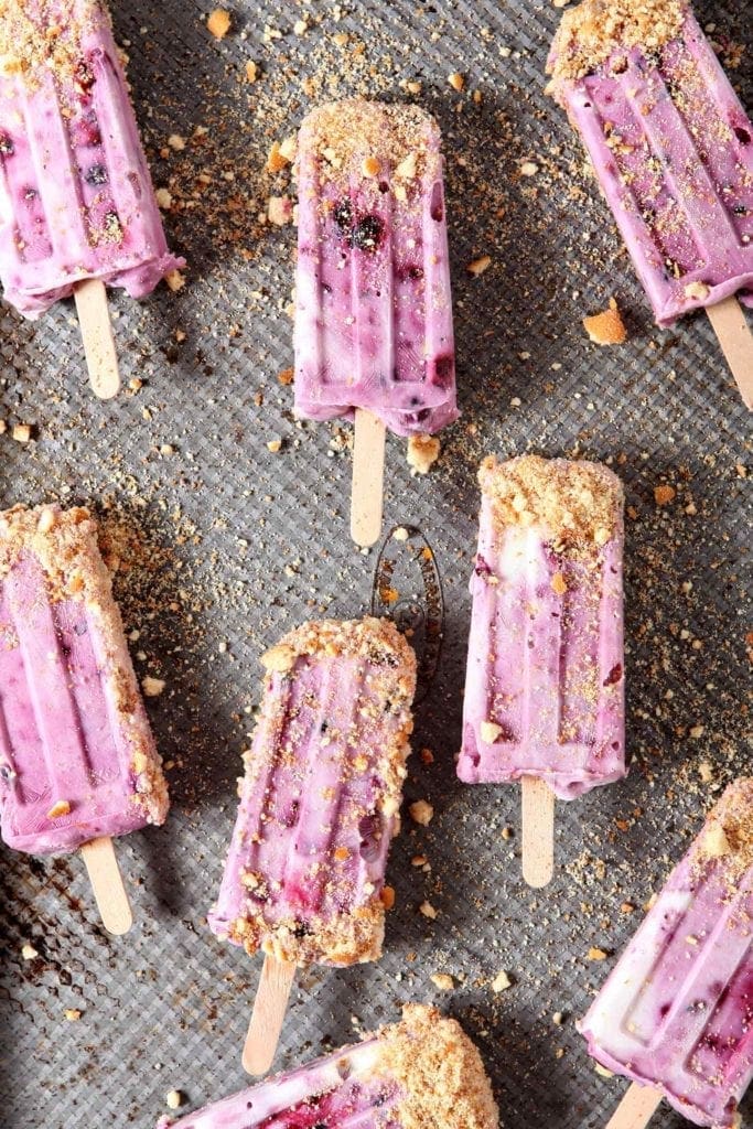 blueberry cheesecake popsicles on a baking sheet