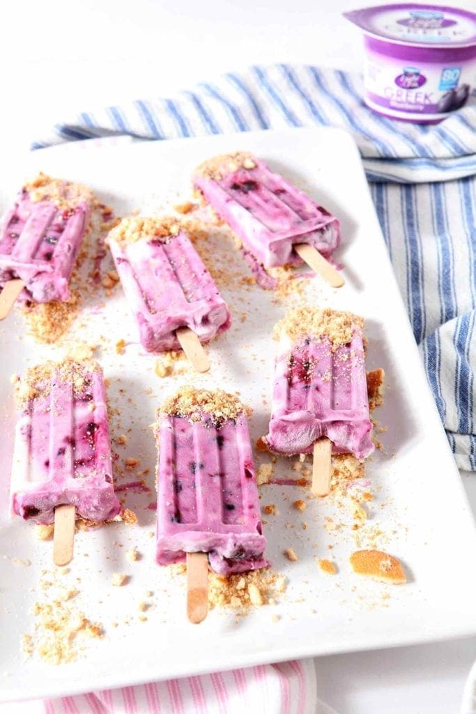 blueberry cheesecake popsicles on a white tray