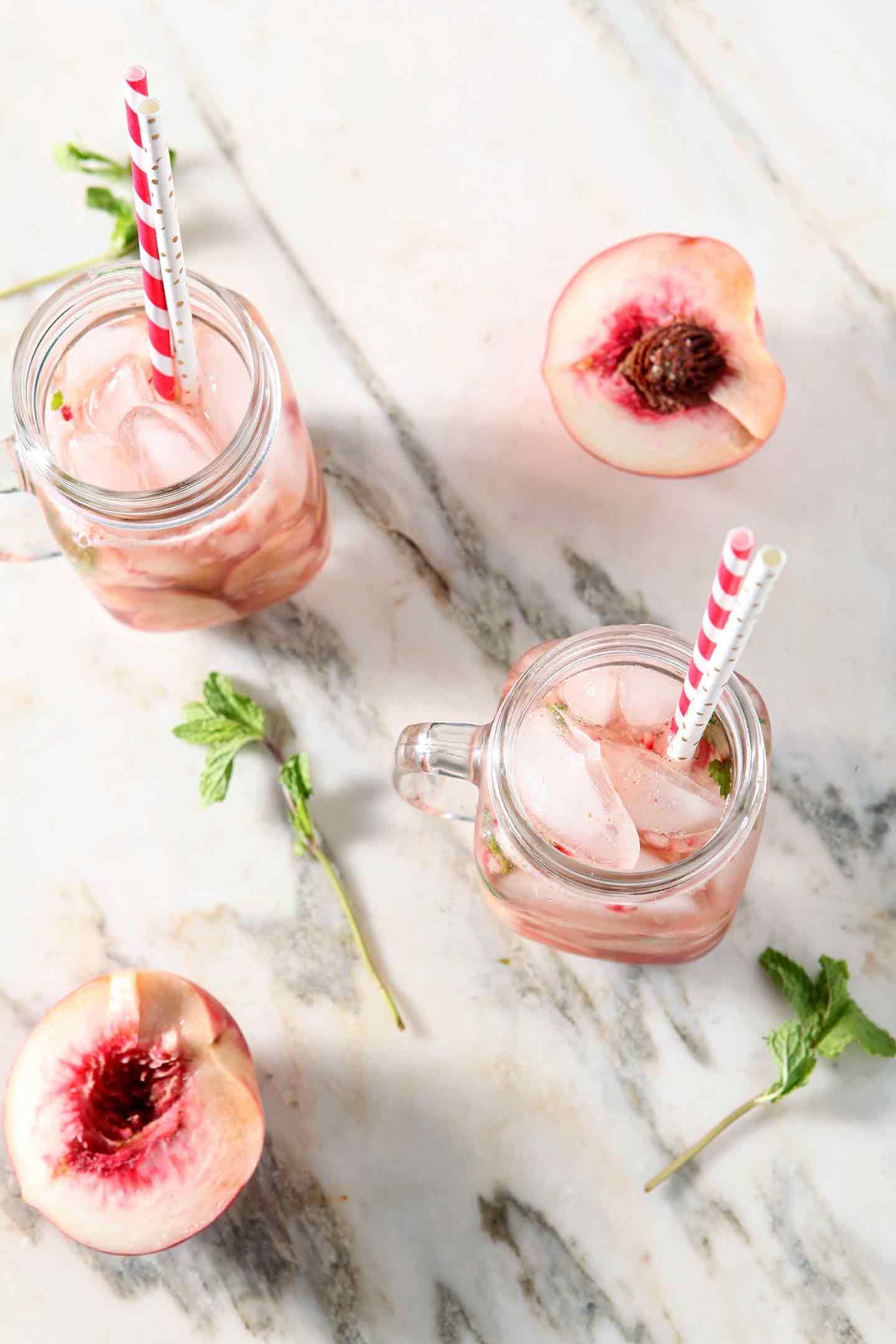 ginger peach punch in two glasses with straws