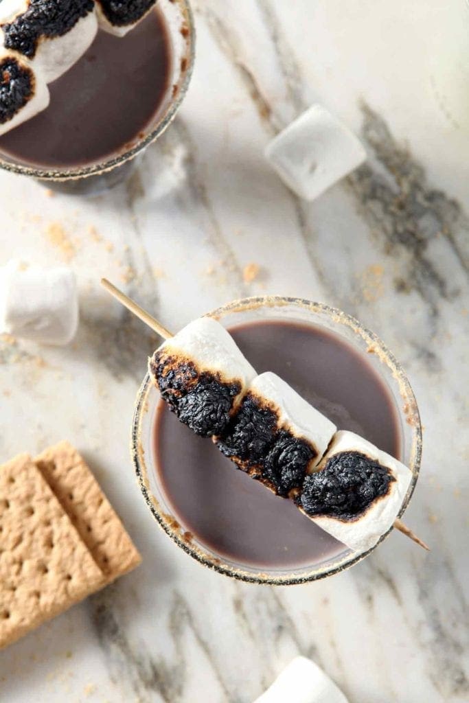 smores martini with marshmallows on a toothpick