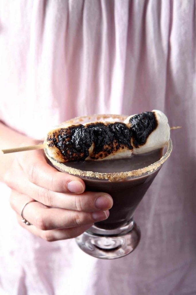 A person holding a smores martini