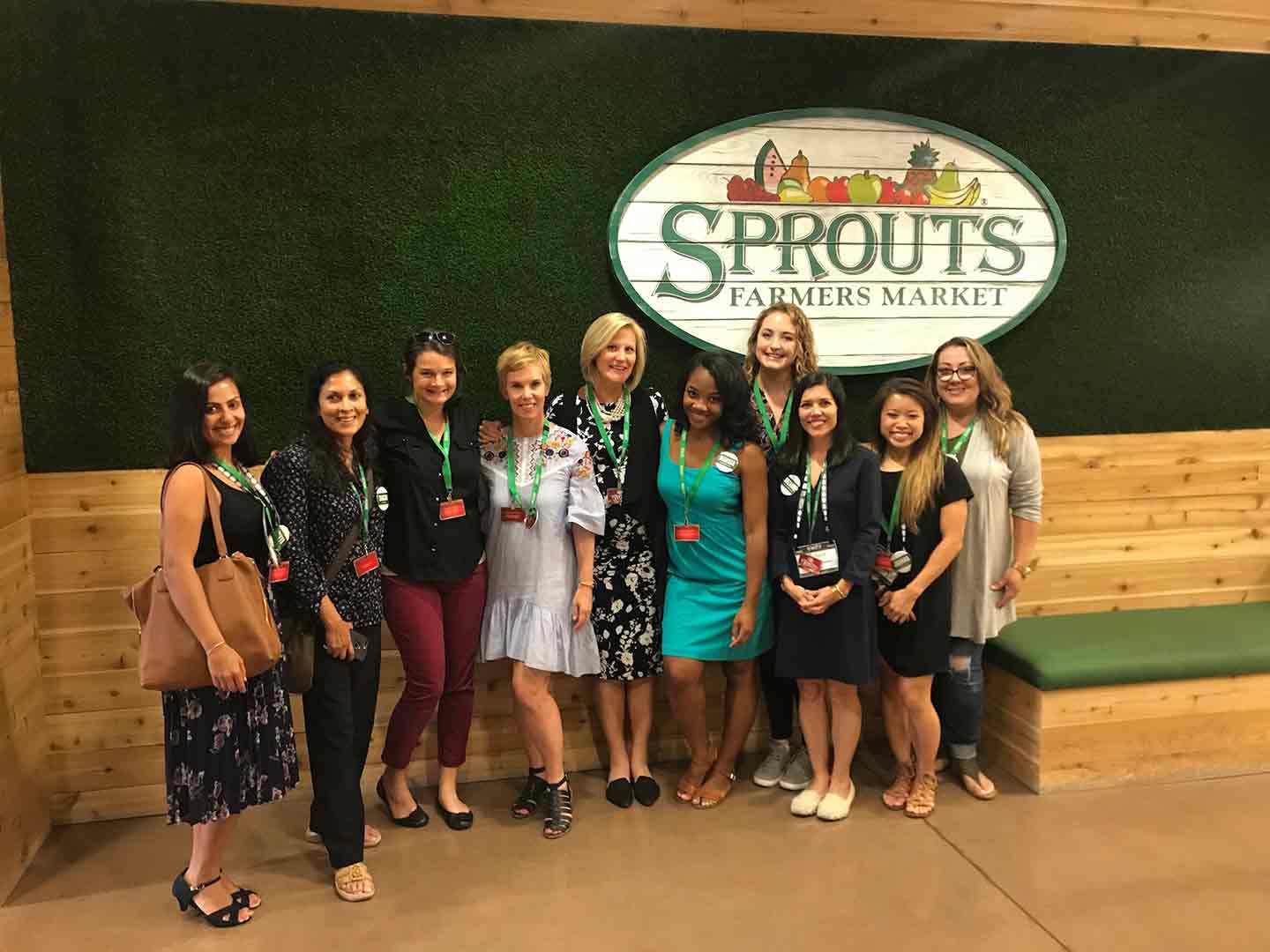 Picture of 10 Women standing under Sprouts Farmers Market sign 