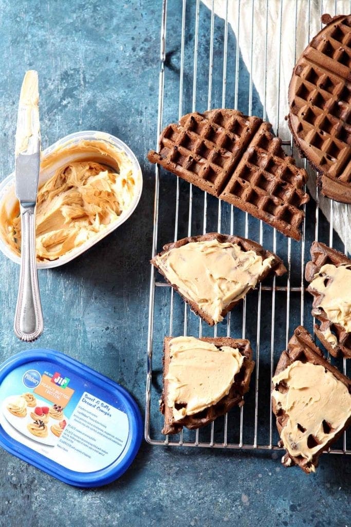 chocolate waffles on a cooling rack with peanut butter