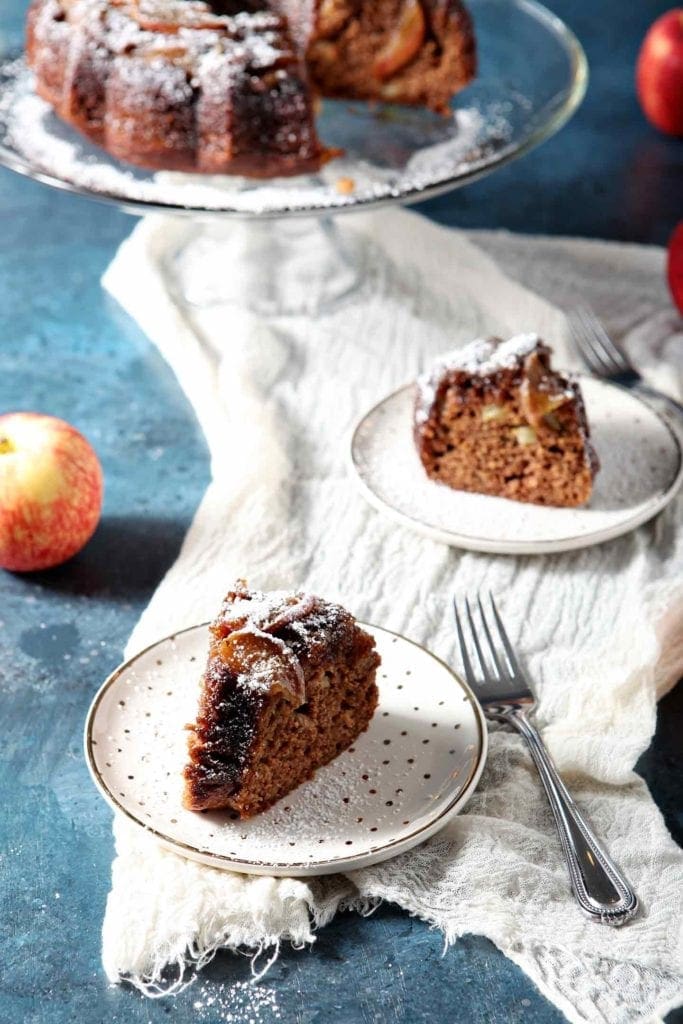 apple upside down cake on white polka dot plates with a fork