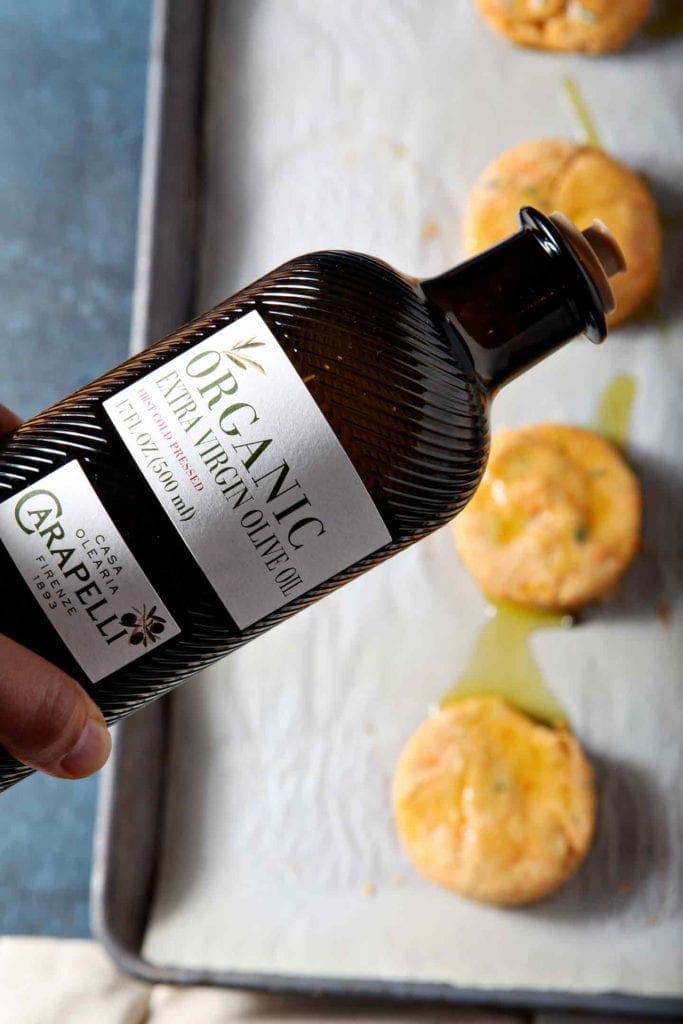 pouring olive oil on biscuits