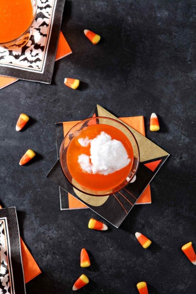 Overhead image of cotton candy floating on top of Candy Corn Martini liquors