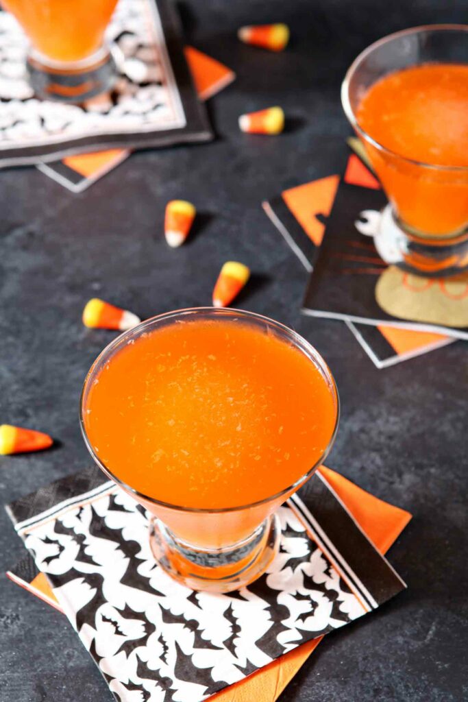 Three glasses of the Halloween drink, garnished with candy corn