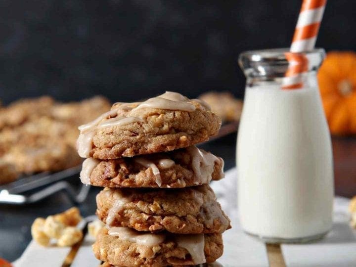 caramel corn cookies stacked with milk behind