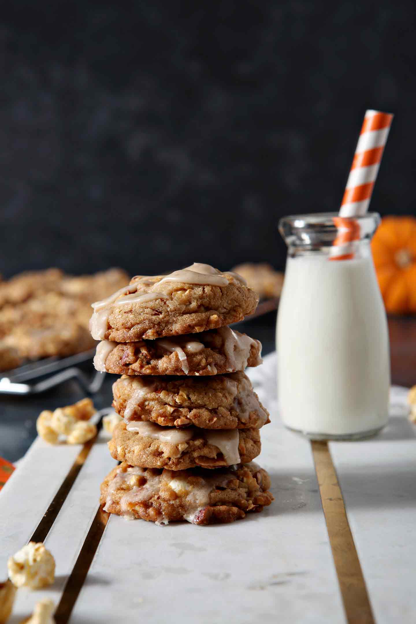 caramel corn cookies stacked with milk behind