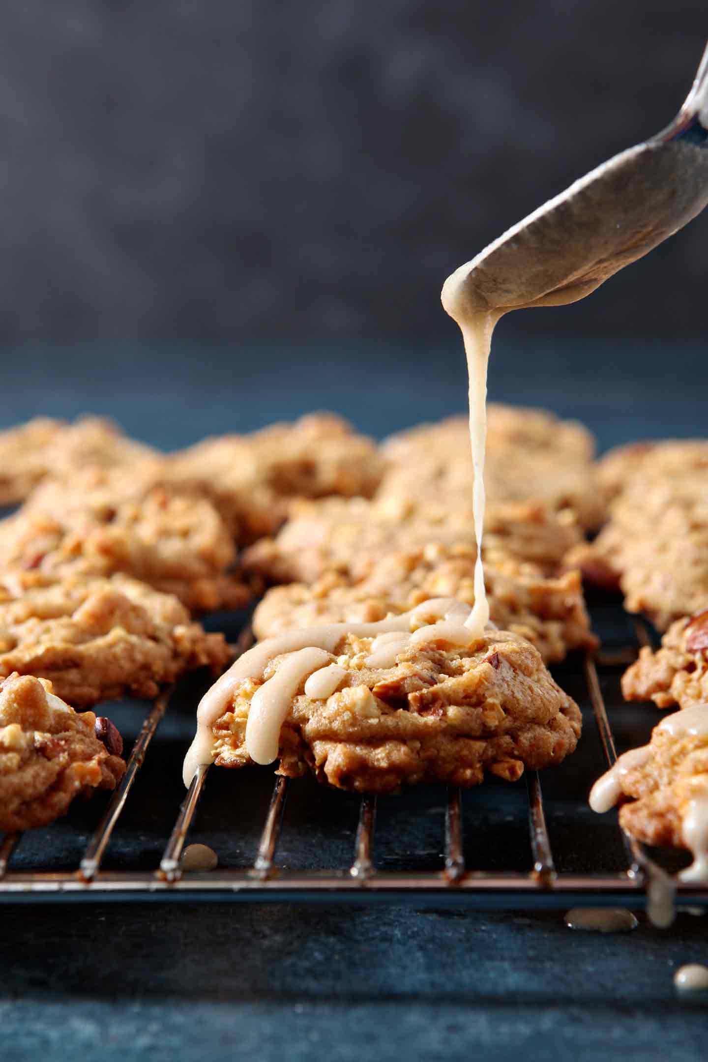 Icing is drizzled onto Caramel Corn Cookies, sitting on a wire cooling rack