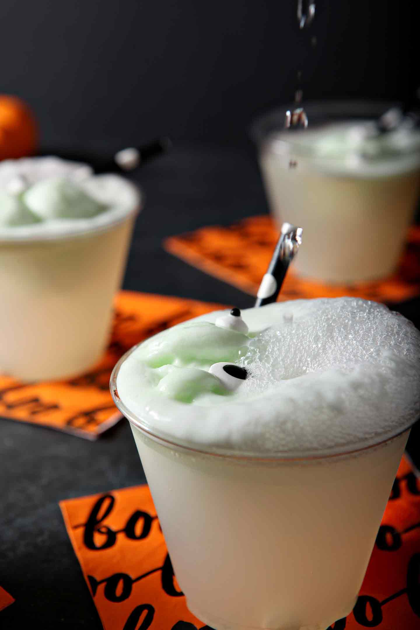 Lemon-lime soda is poured directly on top of the Halloween drink for kids, creating fizz