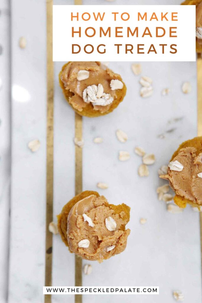 Overhead of iced Peanut Butter Pumpkin Pupcakes on marble with the text 'how to make homemade dog treats'