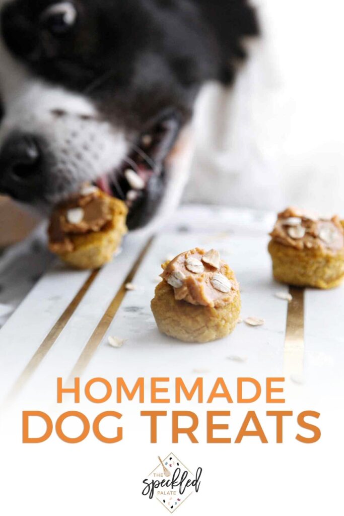 Three Peanut Butter Pumpkin Pupcakes on marble are eaten by a black and white dog with the text 'homemade dog treats'