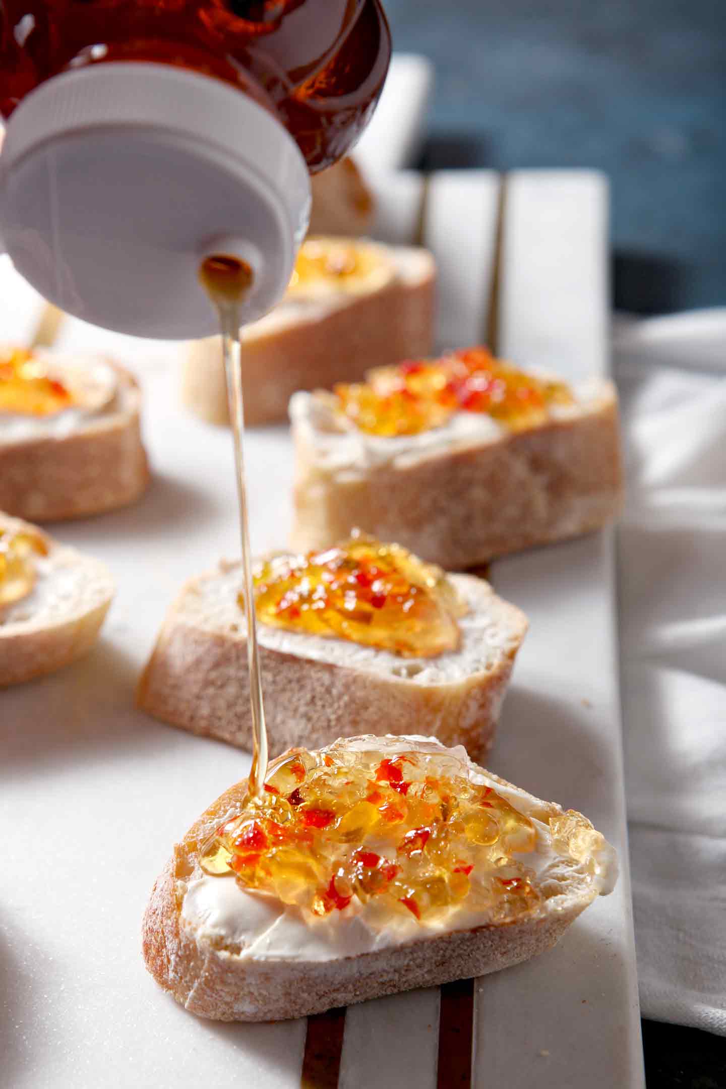 drizzling honey on bruschetta