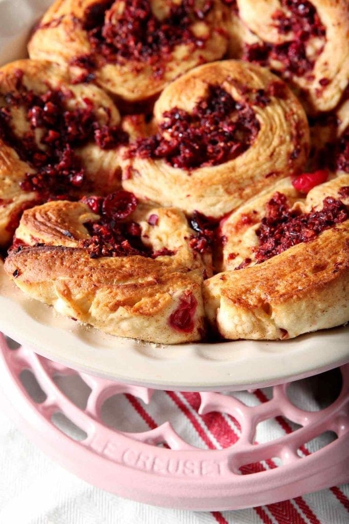 close up of cranberry cinnamon rolls on a plate