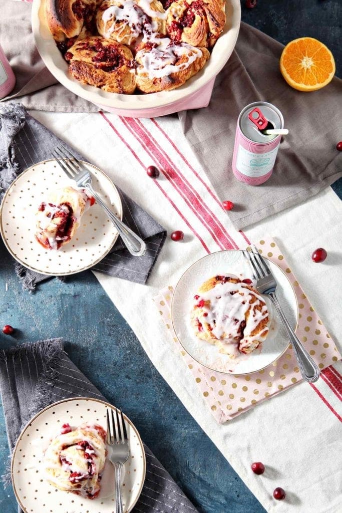 cinnamon rolls on plates with forks