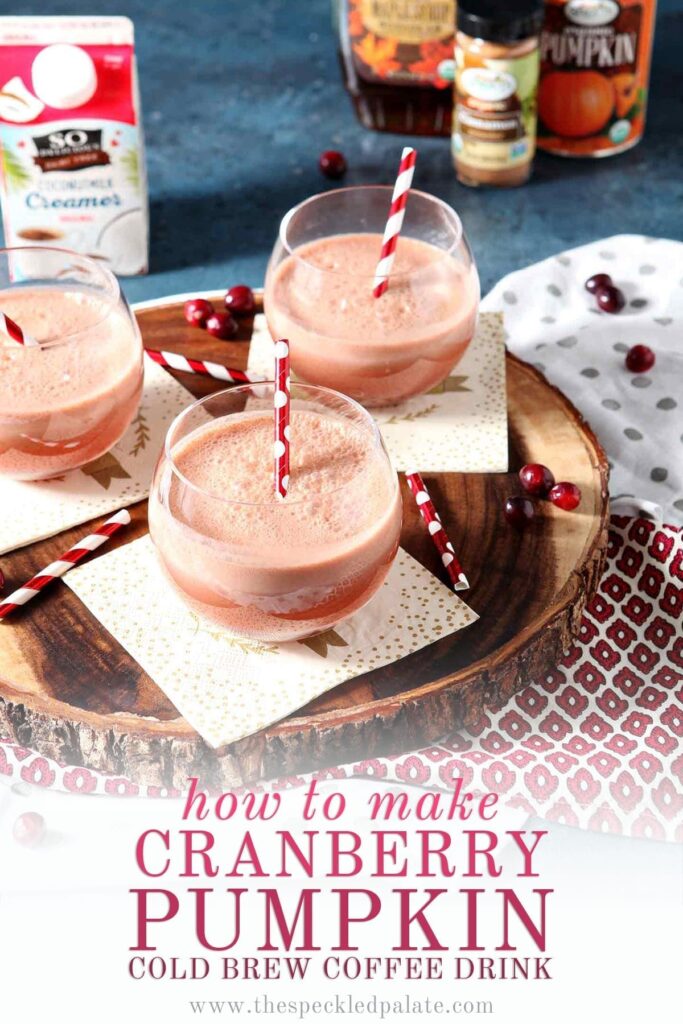 Three Cranberry Pumpkin Cold Brew Coffee Drinks in glasses on a napkins atop a wooden serving platter with the text 'how to make cranberry pumpkin cold brew coffee drinks'