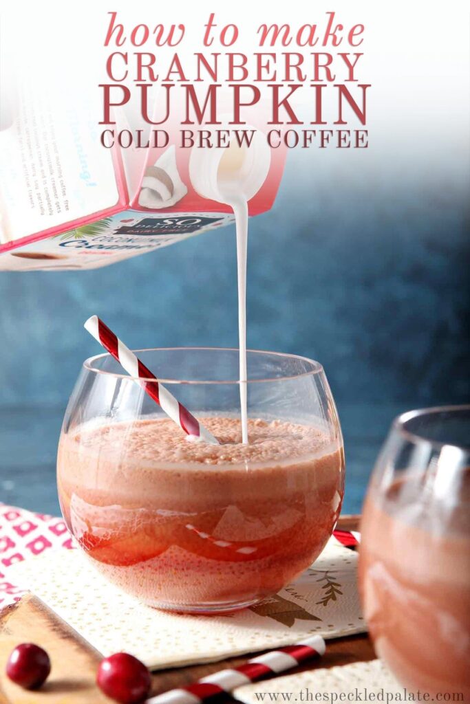 Pumpkin creamer is poured into a cold brew coffee drink in a glass on a wooden serving tray with the text 'how to make cranberry pumpkin cold brew coffee'