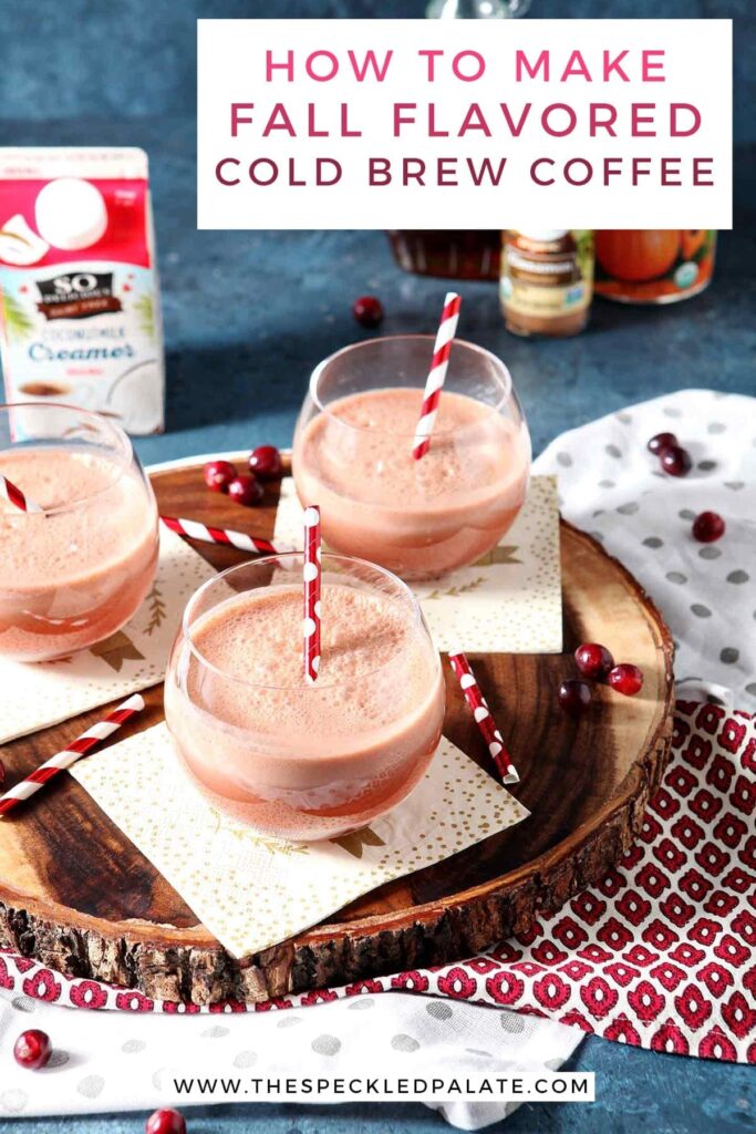 Three Cranberry Pumpkin Cold Brew Coffee Drinks in glasses on a napkins atop a wooden serving platter with the text 'how to make fall flavored cold brew coffee'