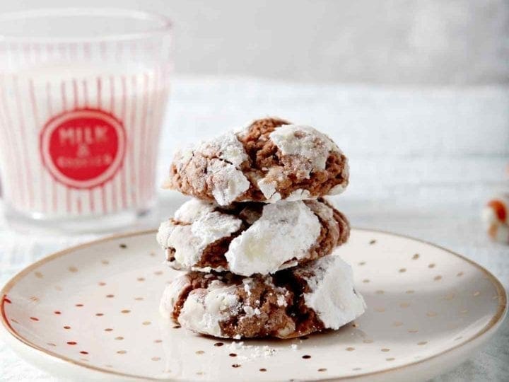 peppermint chocolate crinkle cookies stacked on a small plate