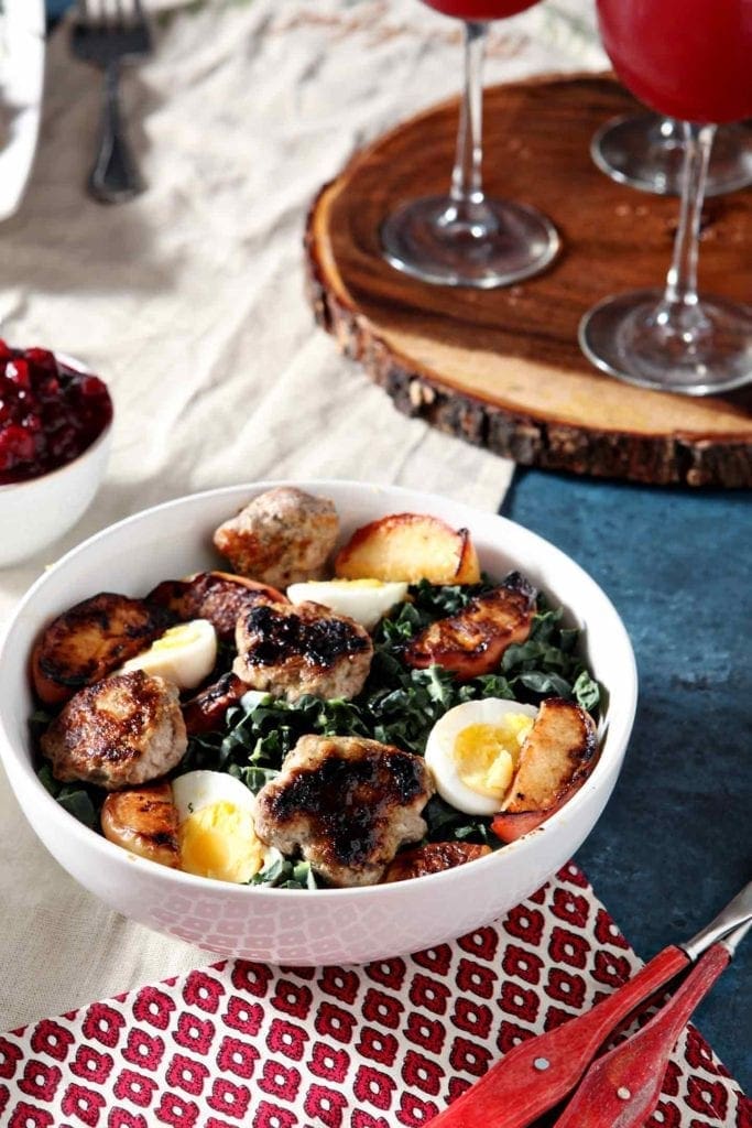 thanksgiving brunch salad in a white bowl with a wood serving tray