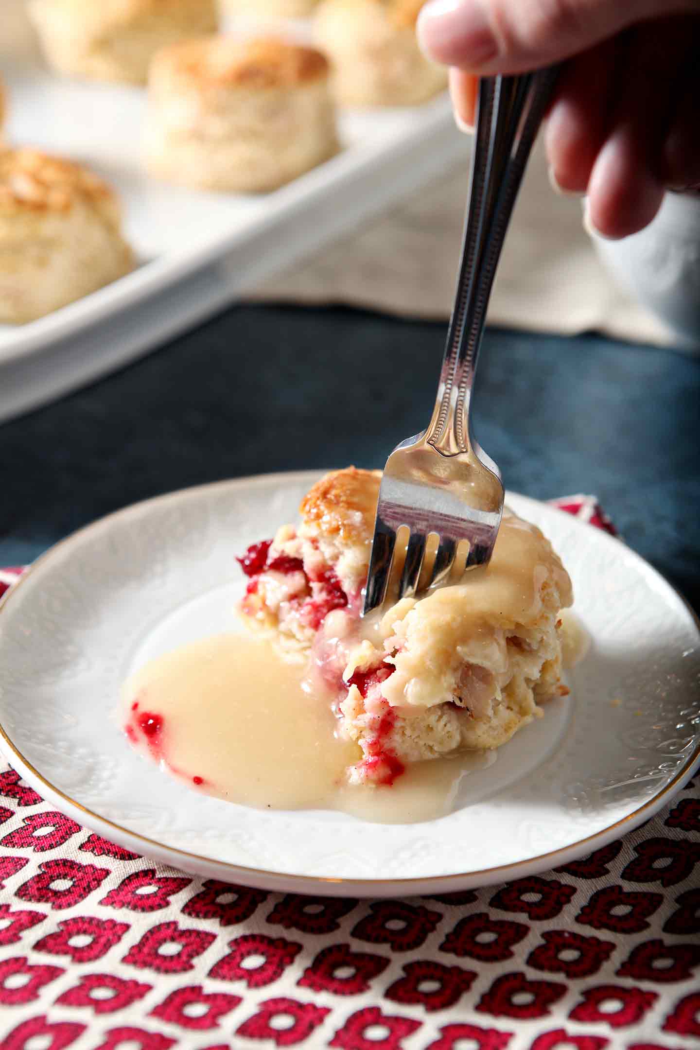 turkey biscuits and gravy on a white plate with a fork taking a bite