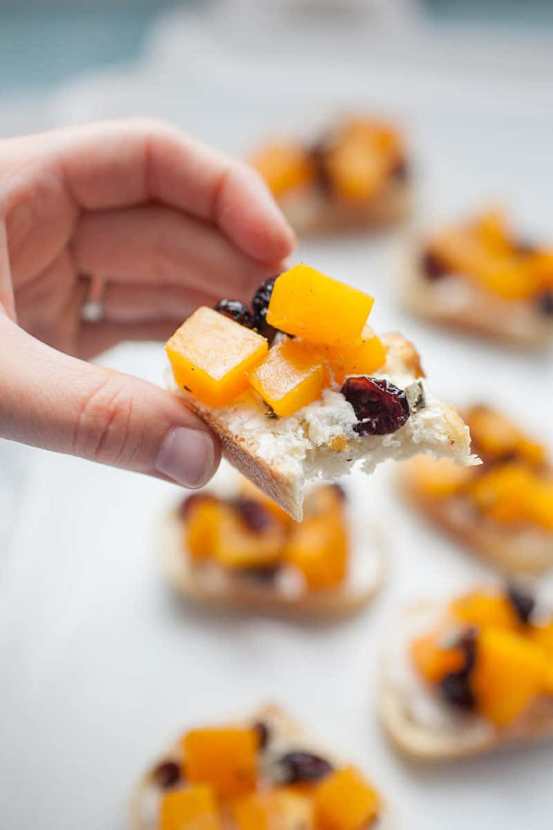 hand holding a butternut squash toast