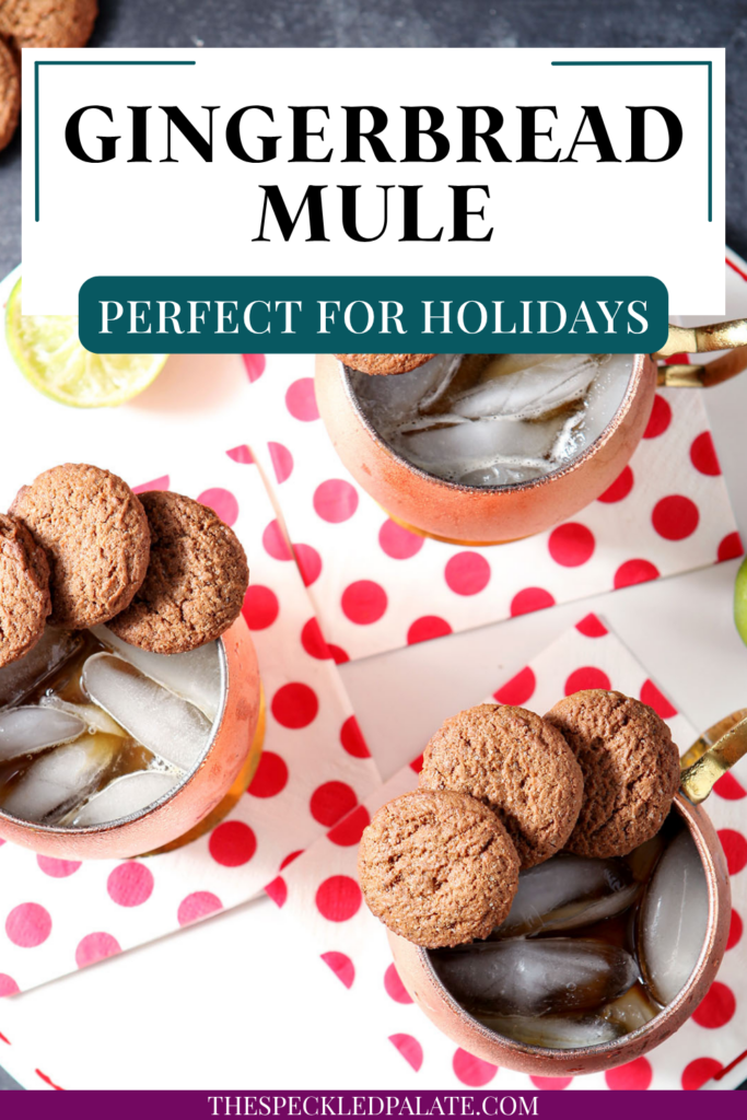 Three copper mugs holding Gingerbread Mules, garnished with ginger snaps, sit on a white platter with decorative dotted red napkins on a dark surface with the text gingerbread mule perfect for holidays