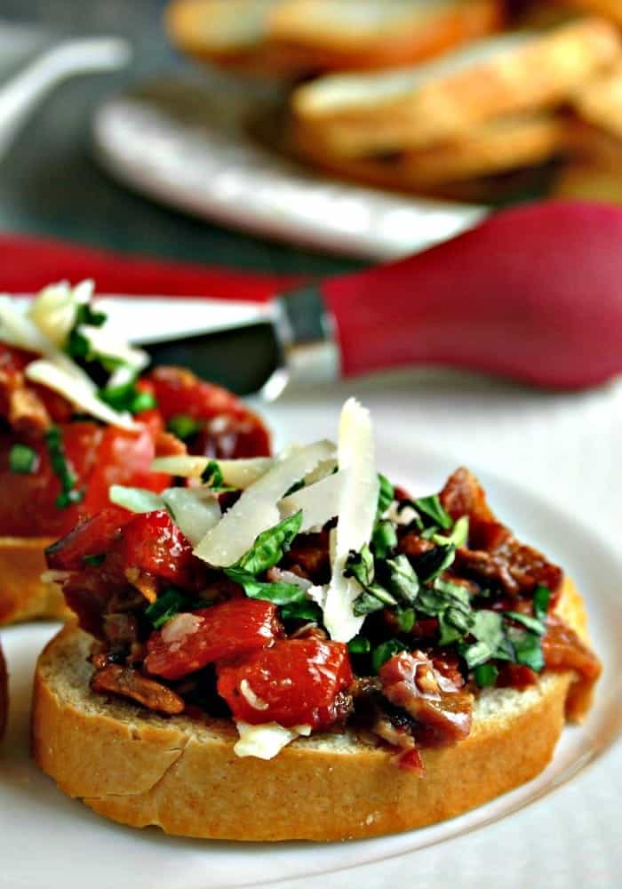 red pepper and bacon bruschetta on a white plate