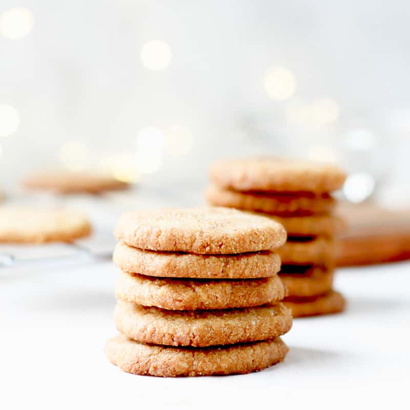 Two vertical stacks of gluten free, flourless brown sugar shortbread cookies on a white countertop