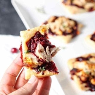 hand holding a cranberry turkey puff pastry tartlet