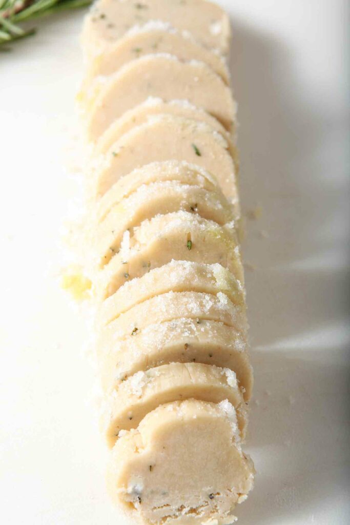 Ginger rosemary shortbread cookie rounds on a plate before baking