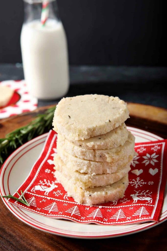 A stack of Ginger Rosemary Shortbread Cookies on a red festive holiday napkin