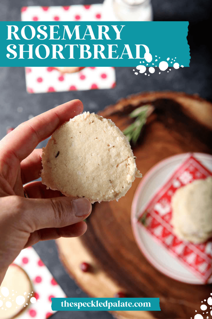 A hand holds a round shortbread cookie with the text rosemary shortbread