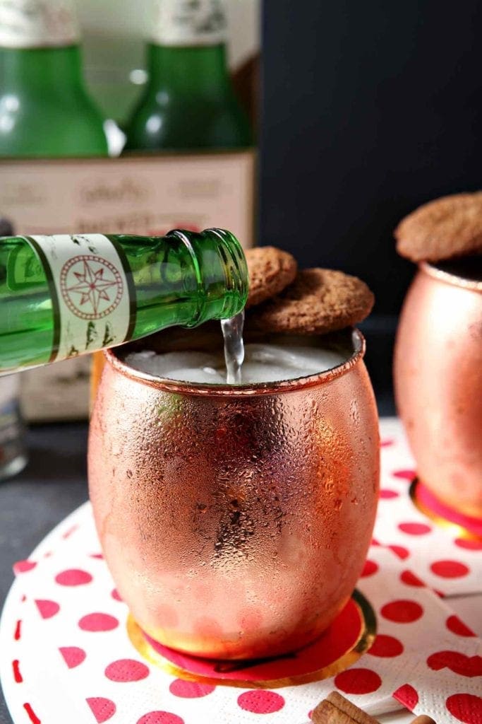 pouring ginger beer in a copper mug