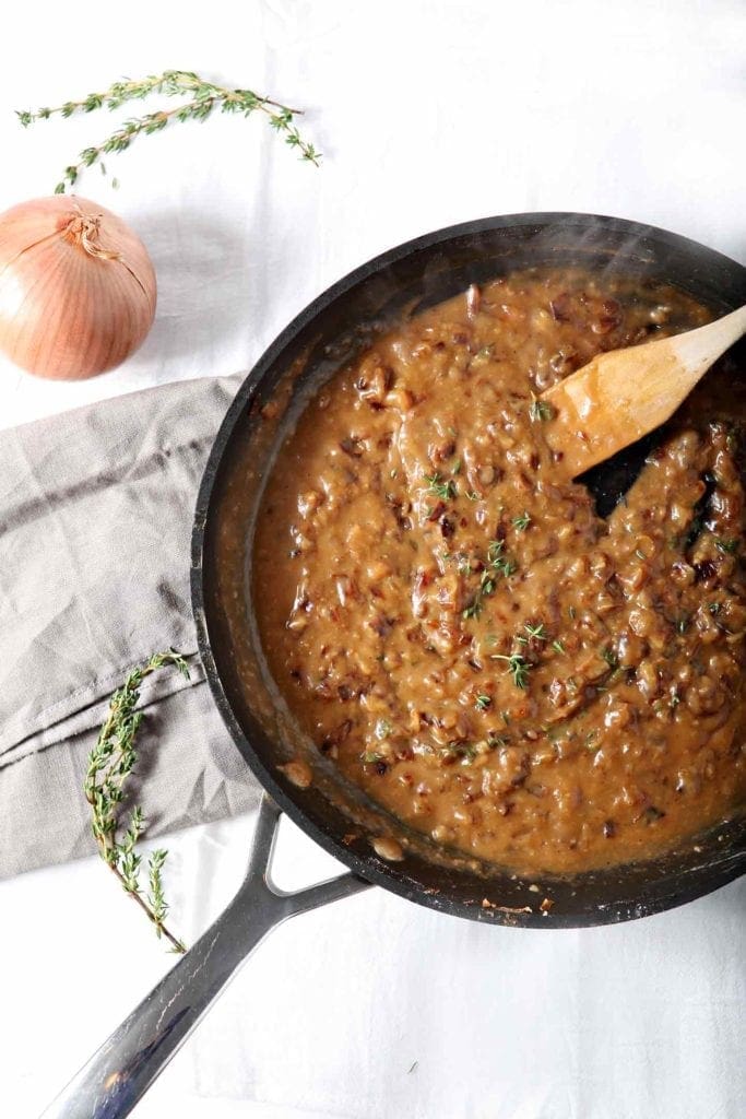 french onion poutine gravy in a black pan