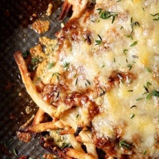 french onion poutine on a black surface