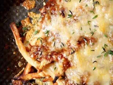 french onion poutine on a black surface