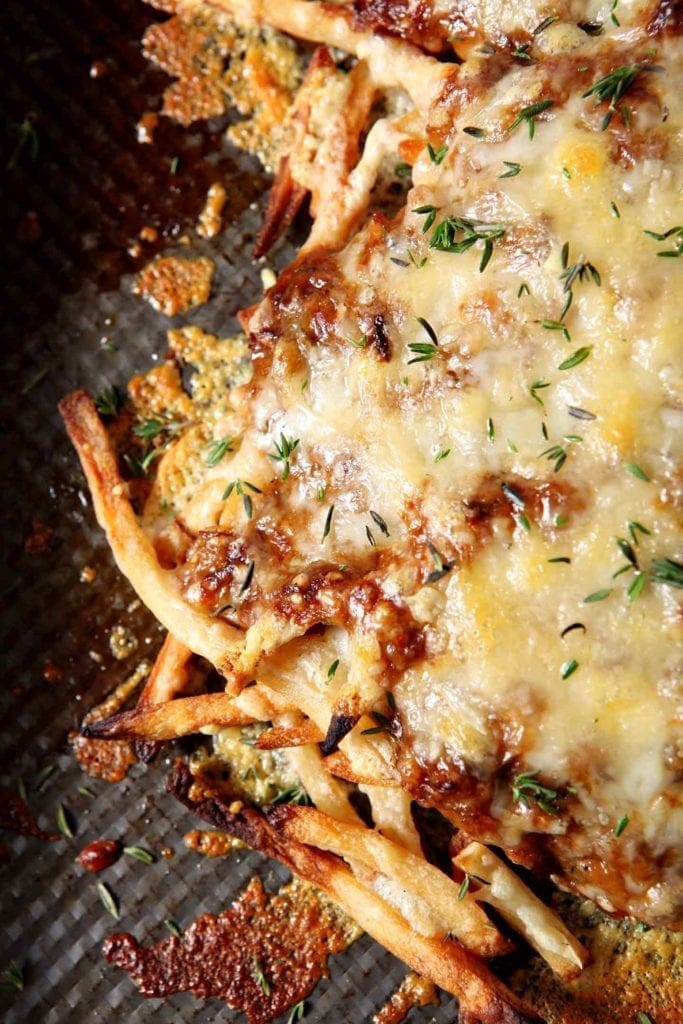 french onion poutine on a black surface