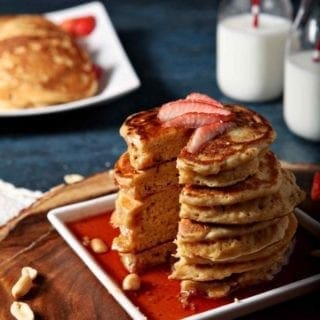 a stack of pancakes with strawberries on top