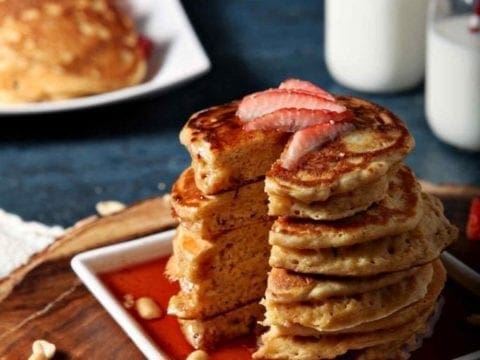 a stack of pancakes with strawberries on top